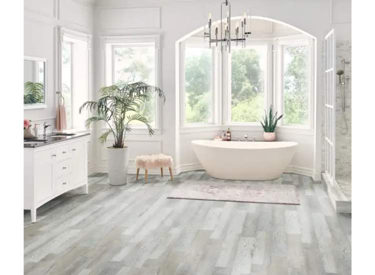 A bathroom with a clean look featuring white walls and vinyl floors creating a simple yet elegant aesthetic