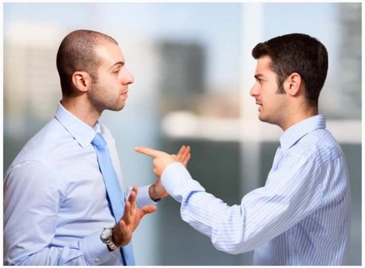 Two people in disagreement, escalating into a heated dispute and argument over differing opinions on a topic.