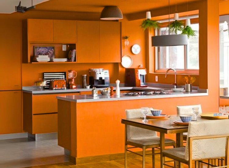 Vibrant orange paint in a small kitchen, infusing the space with energy and warmth for a lively and cheerful atmosphere.