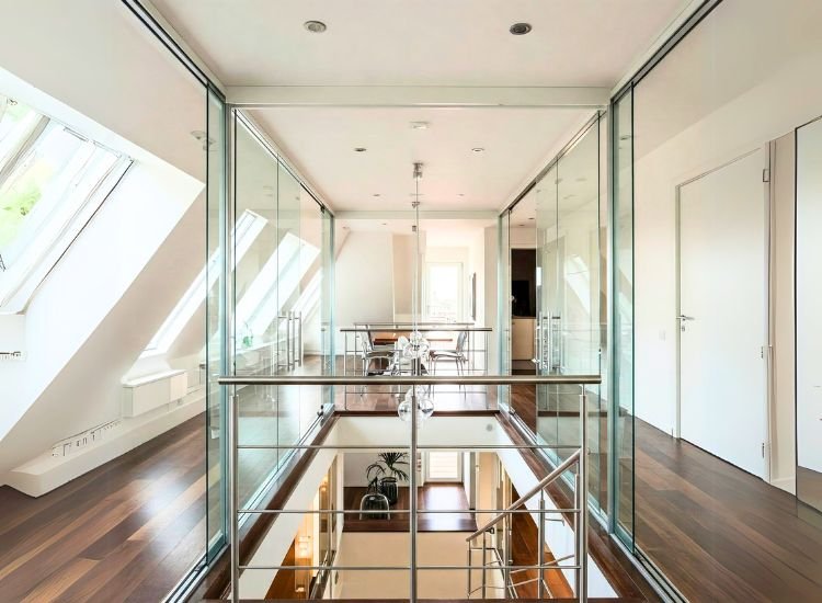 13. Glass And Metal Accents Penthouse design featuring striking glass and metal accents, with sleek glass railings, metallic light fixtures, and contemporary furniture for a modern, stylish touch.