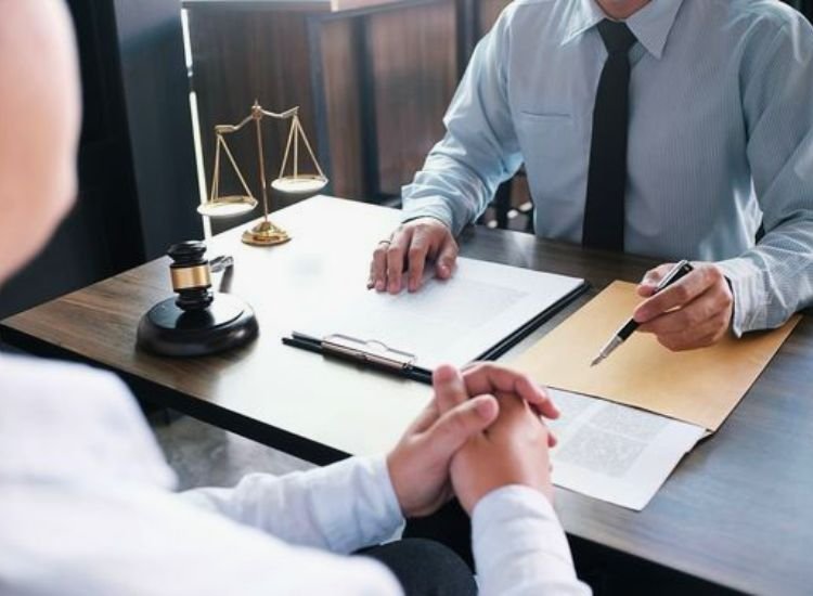 A legal lawyer presenting paperwork to a person, emphasizing the importance of legalities and proper documentation in the home construction process.