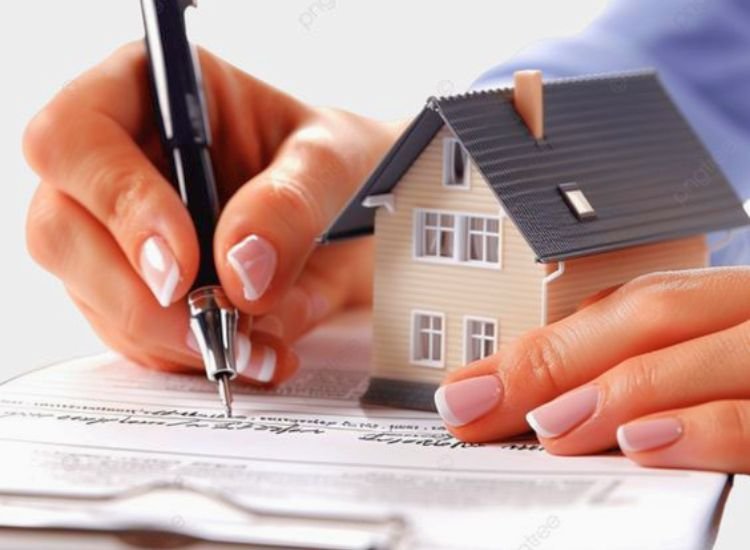 A person signing paperwork for home documentation and certification, essential steps in the pre-home building process.