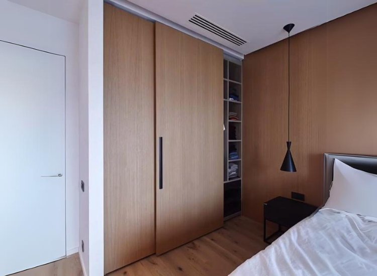 Full-height wardrobe design featuring sliding doors, optimizing vertical space and providing a sleek, contemporary look for any room.