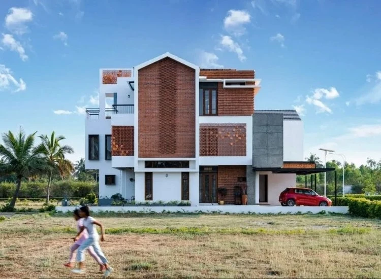 3. Exposed brick finish for house front design Exposed brick exterior of a modern home, blending rustic charm with contemporary design for an inviting facade.