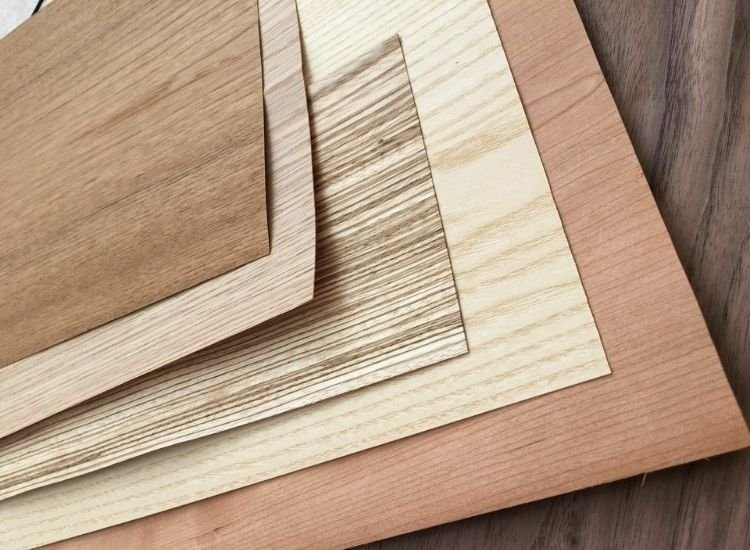 Variety of veneer sheets in wood finishes, highlighting diverse textures and colors for design applications.