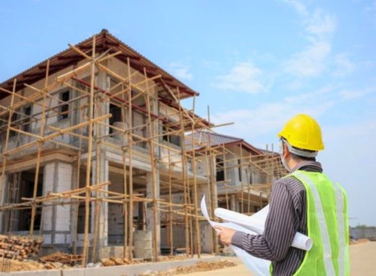 Local structural engineer reviewing the home construction using a checklist to ensure compliance with building standards and regulations.