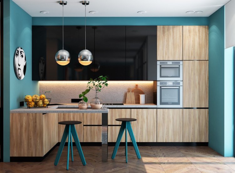 Sleek kitchen featuring blue walls that complement a modern design, enhancing the overall style and sophistication of the space.