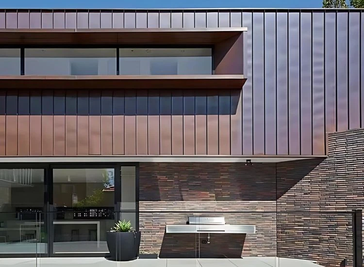 8. Copper sheets for house front design Distinctive copper sheet exterior on a house, offering a sleek, modern look that evolves with time and adds architectural interest.