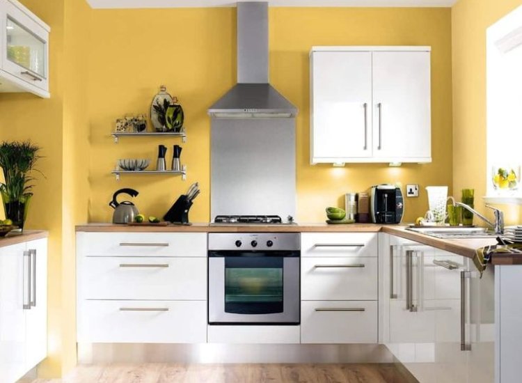 Pastel yellow kitchen walls creating a bold yet cheerful look, enhancing the space with a fresh and inviting vibe.