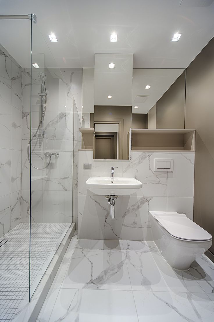 A modern bathroom designed with elegant marble tiles adding luxury and opulent look to the space