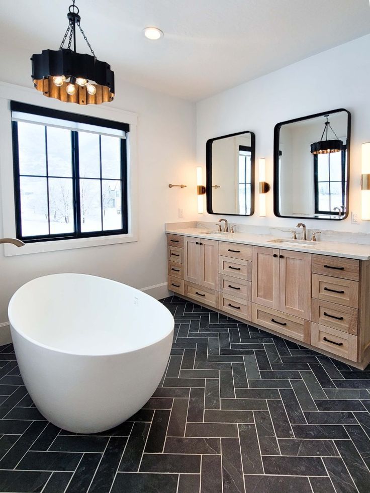 A spacious bathroom featuring a genuine slate tile floor, creating a stunning look for the bathroom