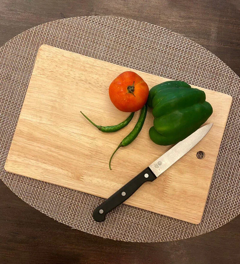 An inviting setup showcasing a rubber wood chopping board with vegetables and a knife