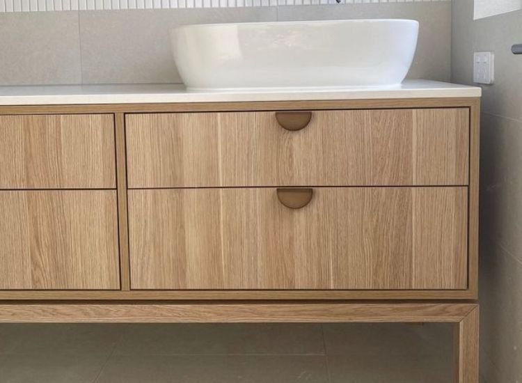 A bathroom with a sink and wooden drawers made of boiling water resistance plywood