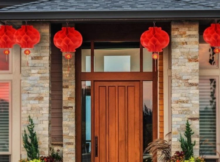 12.Paper Lantern Diwali lighting photo of vibrant lantern glowing on a decorated table with flowers and rangoli for festive celebration