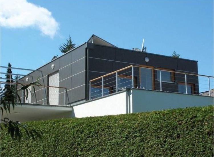 A contemporary house featuring two balconies, showcasing the versatility of High-Pressure Laminate Types