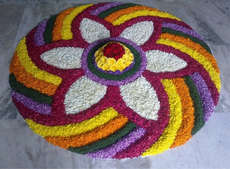 3. Circular Floral Rangoli Colorful circular rangoli made with flower petals, showcasing vibrant patterns for festive decor