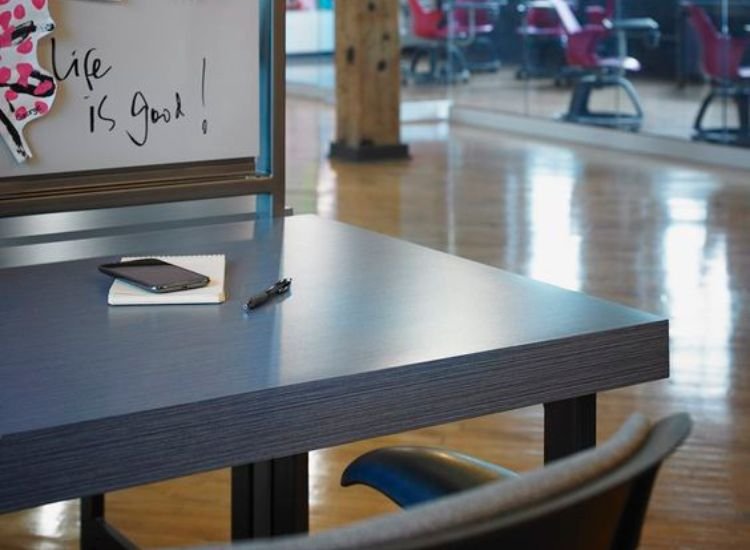 A desk with a whiteboard and chair, featuring a magnetic laminate surface for added functionality