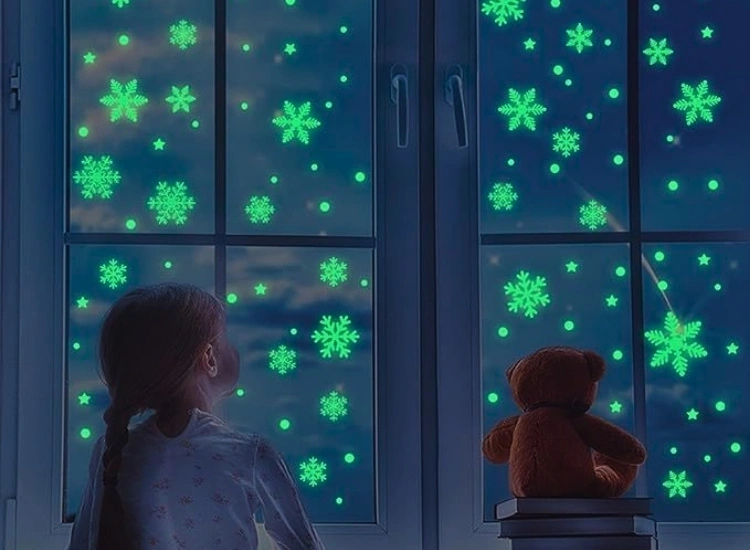 "Glowing snowflake lights on windows, adding a winter wonderland effect. Christmas tree png included."