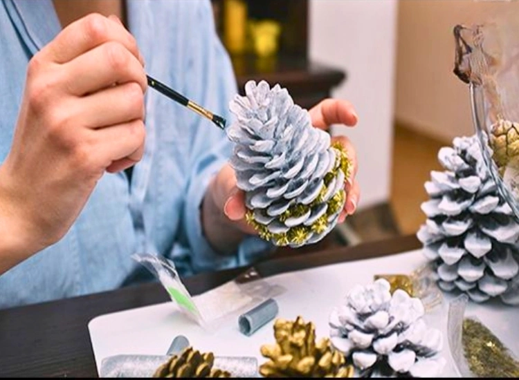 "Painted pinecones used as charming table decor for a festive look. Christmas tree drawing image included."