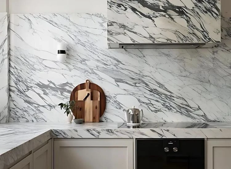 10. Calacatta marble kitchen countertop backsplash White Calacatta marble with black veins countertop, backsplash and over head cabinet design of the kitchen.