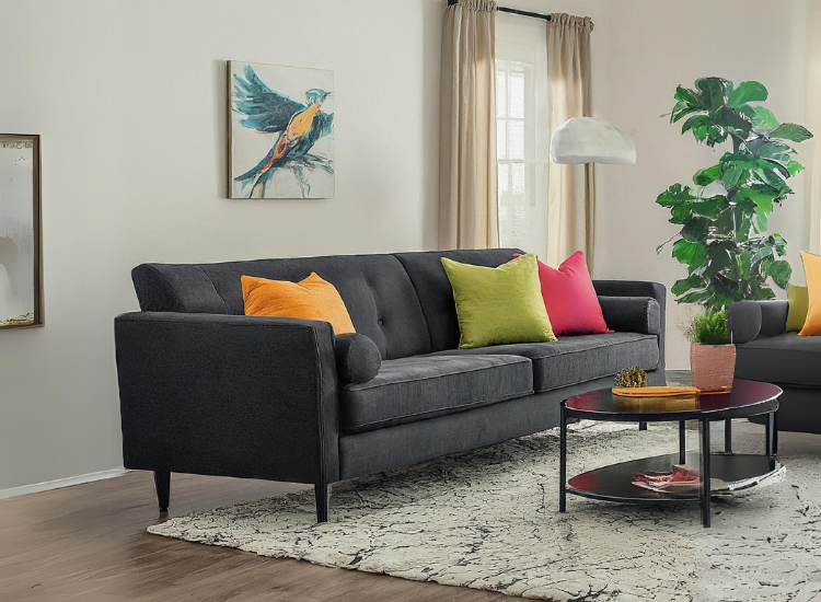 A dark-colored sofa with pink and orange cushions contrasts with the room colors, creating a vibrant focal point and adding visual interest.