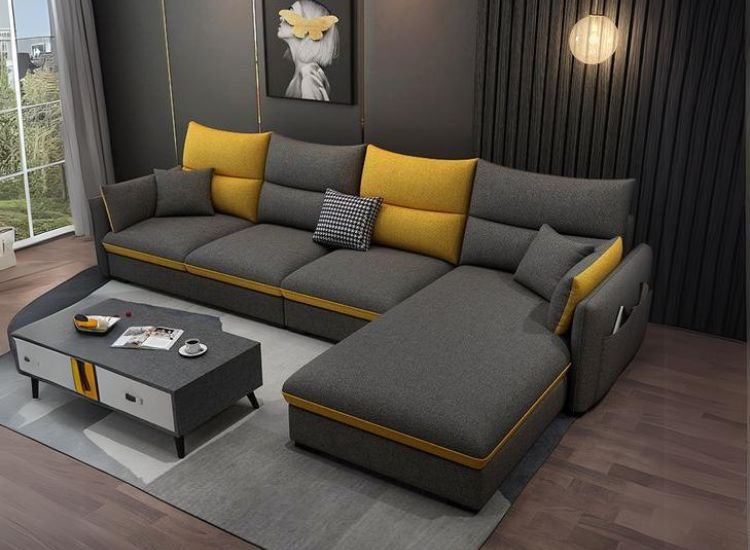 A dark living room with a dark sofa and bright yellow cushions creates striking visual harmony and a stylish contrast.