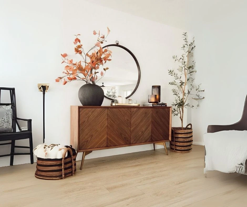 24 A sideboard finished with brown colored veneer with mirror and vases, creating an elegant and stylish ambiance