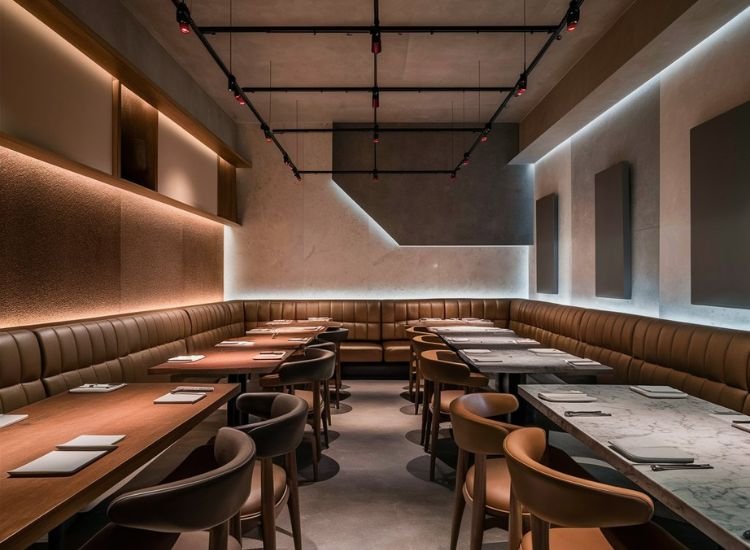 Cozy restaurant dining area illuminated with LED recessed lighting, highlighting the color and texture of the interior design for a warm ambiance.