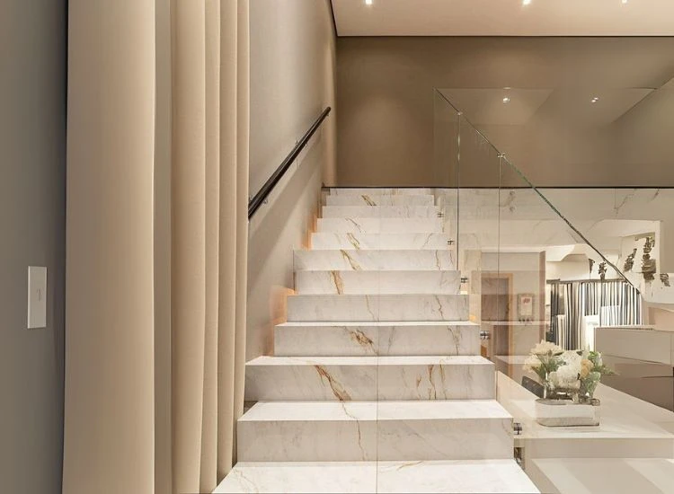 33. Italian marble staircase design White italian marble with gold veins stairs adding drama to the staircase design of a home.