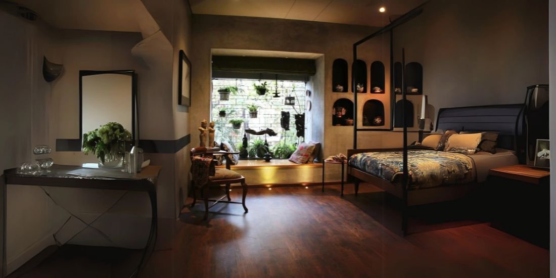 A comfortable bedroom showcasing dark ebony colored and elegant soft flooring providing a peaceful touch.