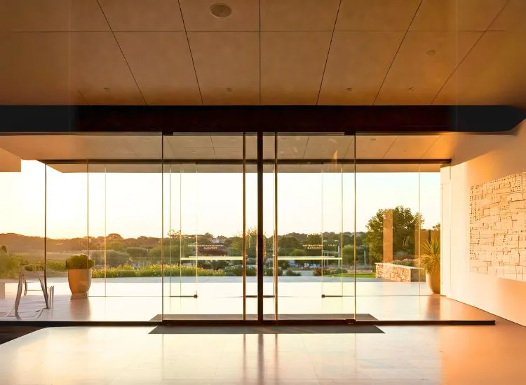 19. Glass Door Modern glass door design adding elegance and sophistication to house door types, perfect for contemporary interior and exterior designs.