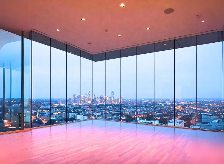 3. Floor To Ceiling Glass Windows Contemporary living room with floor-to-ceiling glass windows, adding a modern touch and flooding the space with natural light.